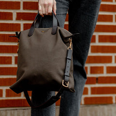 A person with a Mismo Army Dark Brown M/S Canvas Shopper Tote.