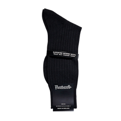 A pair of Pantherella Black Merino Wool Ribbed Ankle Socks on a white background, perfect for your sock drawer.