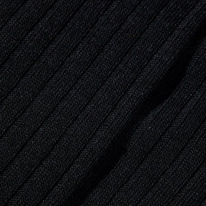 A wardrobe essential, this close up image showcases the comfort of Pantherella's Black Merino Wool Ribbed Knee Socks.