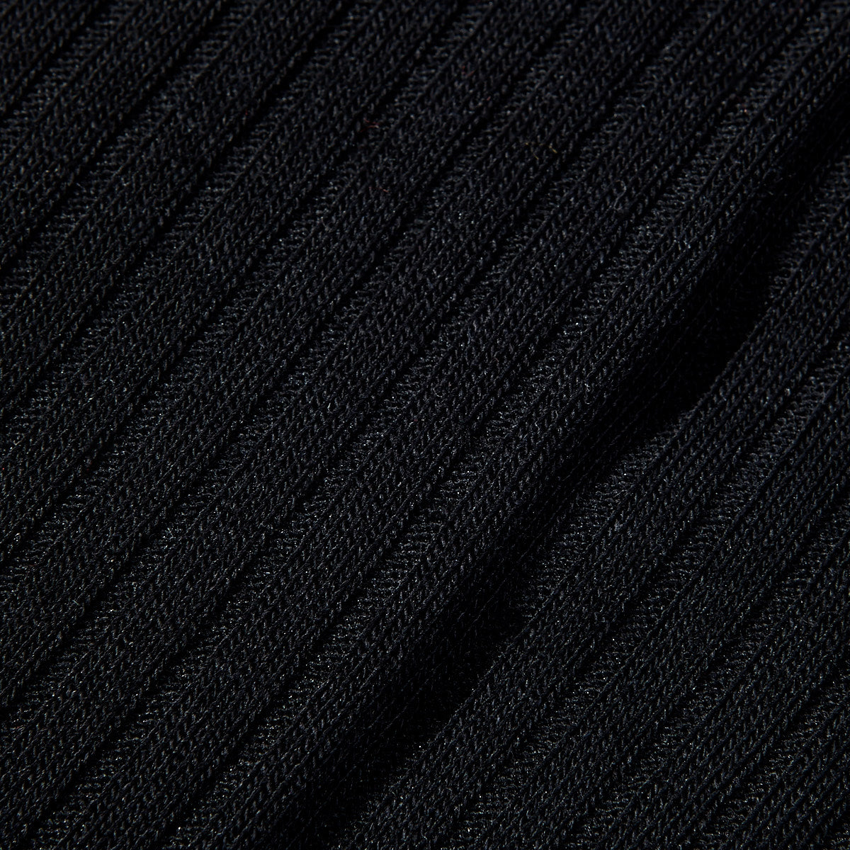 A wardrobe essential, this close up image showcases the comfort of Pantherella's Black Merino Wool Ribbed Knee Socks.