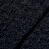 A close up image of Navy Merino Wool Ribbed Ankle Socks made from black knitted fabric by Pantherella.