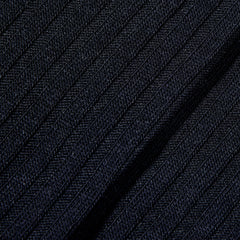 A close up image of Navy Merino Wool Ribbed Ankle Socks made from black knitted fabric by Pantherella.