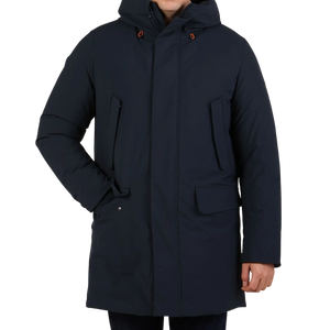 A man in a Blue Black Padded Wilson Arctic Parka by Save The Duck with technical down.