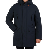 A man in a Blue Black Padded Wilson Arctic Parka by Save The Duck with technical down.