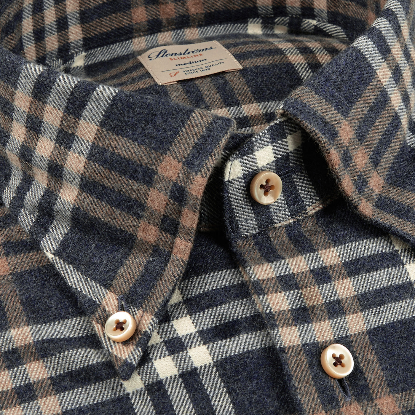 Close-up of the Blue Checked Cotton Flannel Slimline Shirt by Stenströms, highlighting the beige and white plaid pattern with a tag beneath the collar.