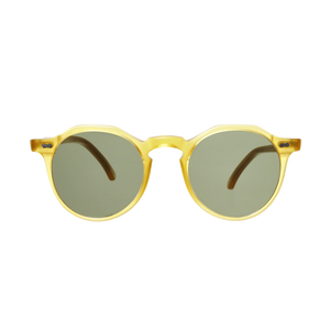 A pair of Lapel Honey Frame sunglasses by The Bespoke Dudes with Bottle Green Lenses on a comfortably fitting green background.