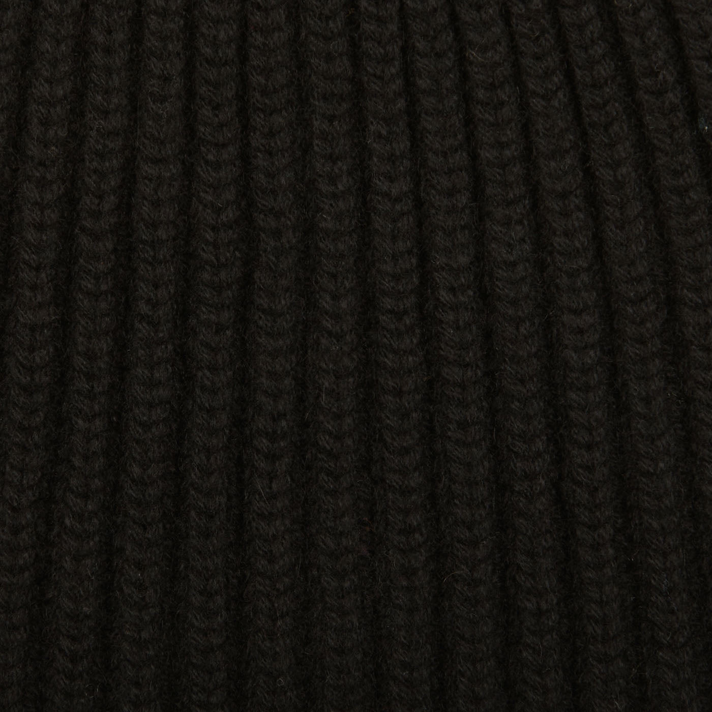 A close up of William Lockie's Black Cashmere Ribbed Short Beanie, Scotland's finest solid black ribbed beanie.