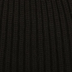 A close up of William Lockie's Black Cashmere Ribbed Short Beanie, Scotland's finest solid black ribbed beanie.